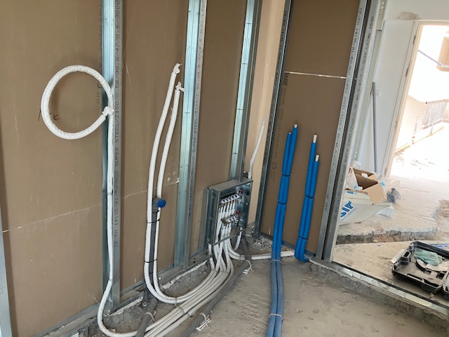 Detail of installed building services routed within a partition wall.