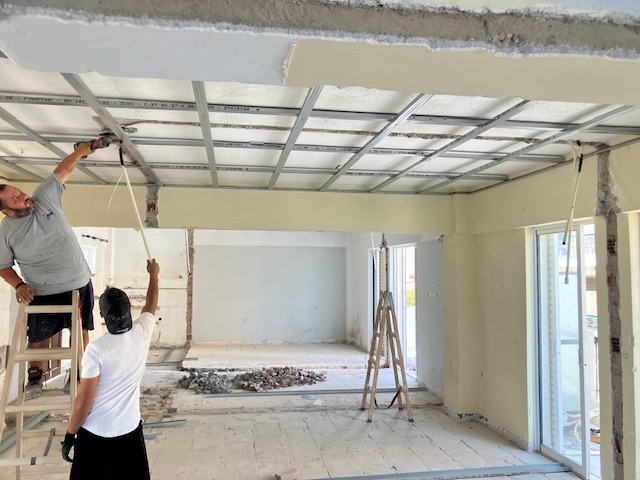 Workers installing the metal ceiling framework.