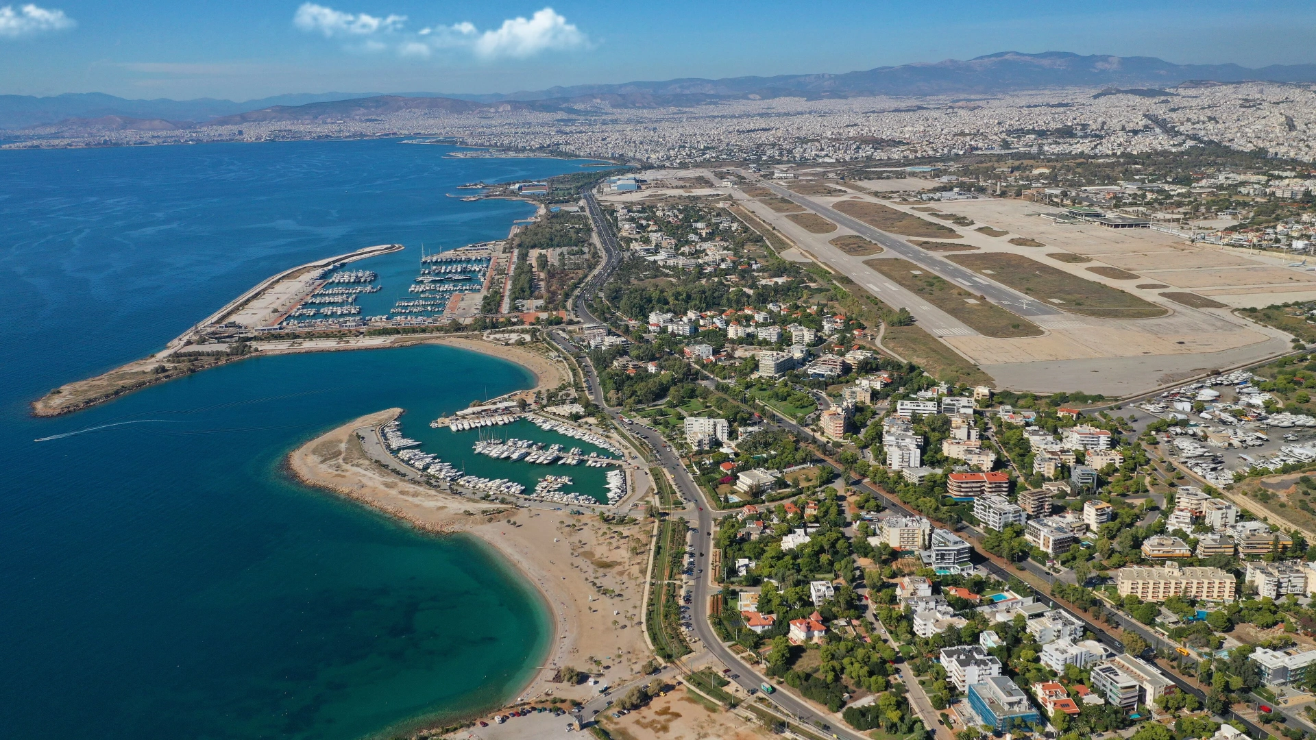 Seaside beach and tavernas in Artemida at golden hour