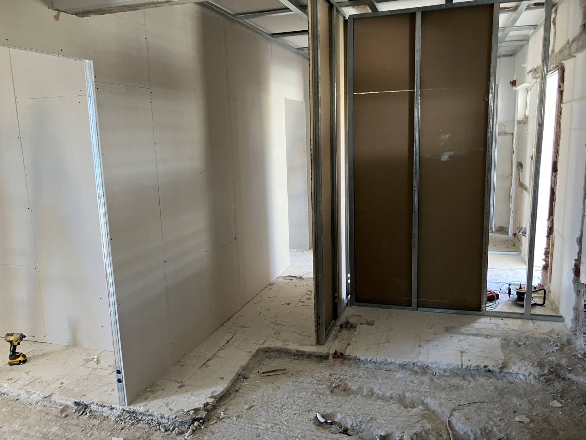 Spacious residence interior with drywall partitions, exposed ceiling framing and long architectural sightlines.